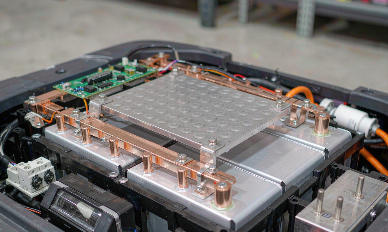 AMR lithium battery pack with busbars, BMS PCB, and opportunity-charge docking contact block