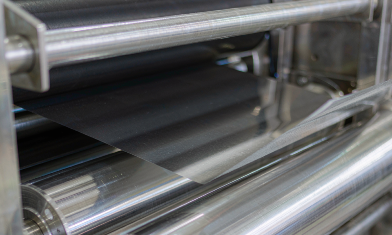 Semi-solid state battery dry electrode processing: matte black electrode film pressed between polished steel rolls